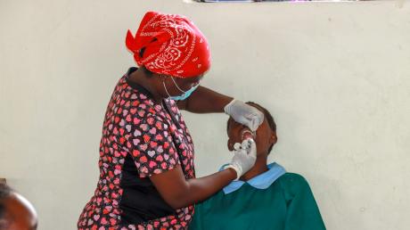 Dentist extracting a tooth from a young girl.