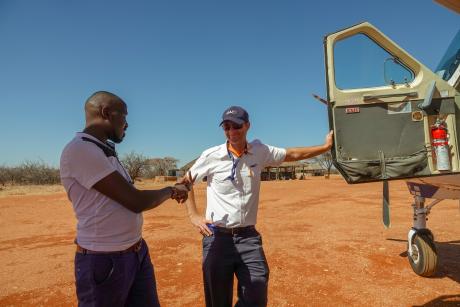 Dr Jadiel having a conversation with Pilot Daniel Loewen-Rudgers shortly after landing in Kalama airstrip.