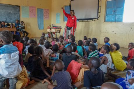 A representative from CBN  conducts a children's ministry.