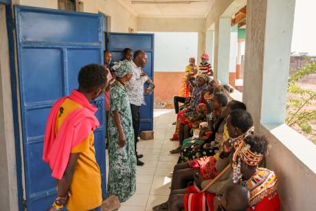 The pastor conducting a prayer session with patients at the Bura mobile clinic.