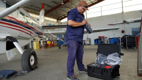 Maro Kopi getting the hand-held test equipment out of the box at the MAF Mt Hagen hangar