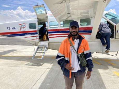 Anthon Mouyai standing by an MAF plane before departing