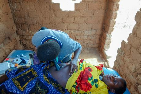 A nurse conducting a prenatal examination for a pregnant woman during the mobile clinic.