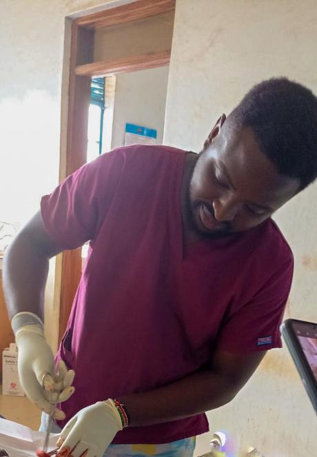 Dr. Samuel Njoroge conducting a surgical procedure to alleviate a lipoma in a patient.