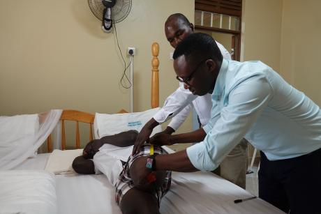 Dr. Bosco measures girl's stump for prosthetic limb