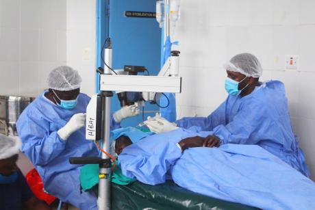 Eye surgeons operating on patient