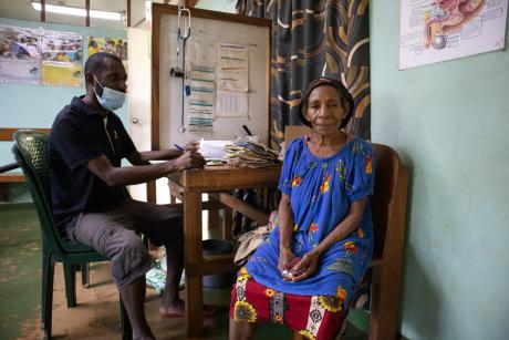 Community Health worker, Tony Aima attending a patient at the Mougulu health centre