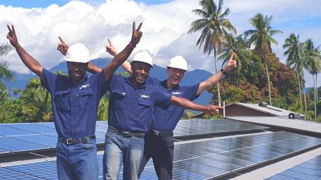 David Inava, Simeon Tom and Lukas Schadegg pictured after a solar installation on the EBC Print shop in Lae