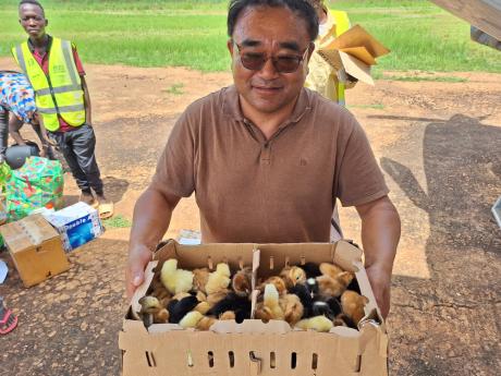 Reverend Park receiving his chicks and Maridi Airport