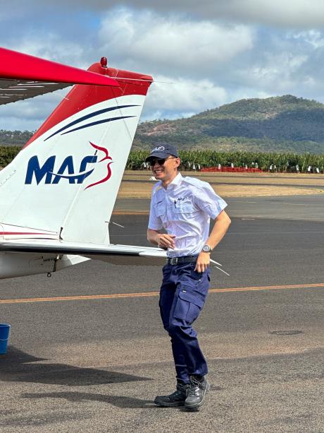 A student pilot at the tail of a small plane