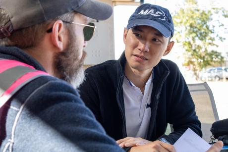 A young man is briefed by a flight instructor