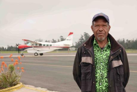 Pastor stands in front of MAF plane