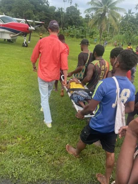 Silas carried to the aircraft at Samban_photo Karrie Pryor