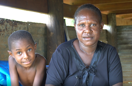 Esther Waliah and her son sitting outside their house