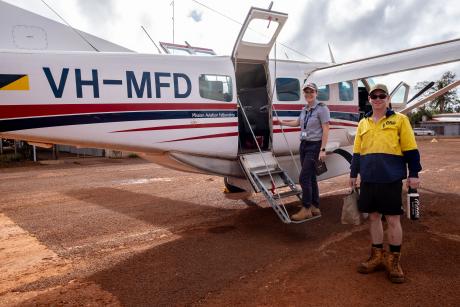 Pilot and passenger in front of aircraft