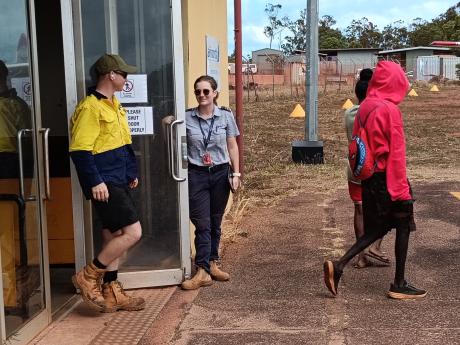 Pilot holding terminal door open for passengers
