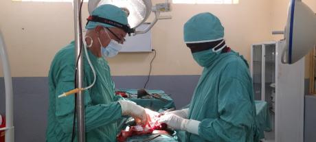 Mark and colleague performing surgery on a patient
