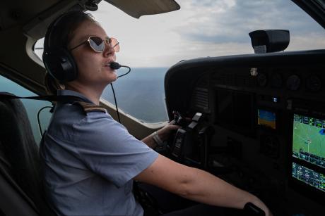 Pilot looking out of aircraft window in flight