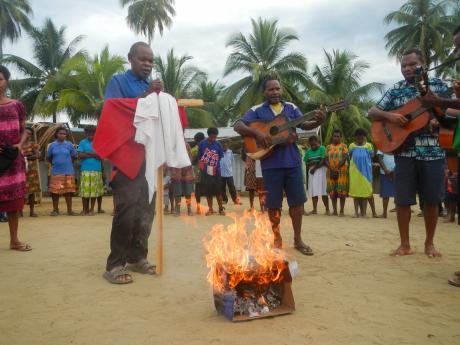 Some village people act in a drama with guitars and props