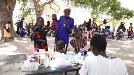 Patients receive medicines at the pharmacy table 