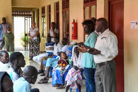 Pastor Simon Peter opens the outreach with prayer 