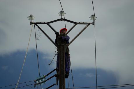 Electrician working on a power line in Toamasina