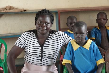Teacher Rebecca Ojaba with her pupils 