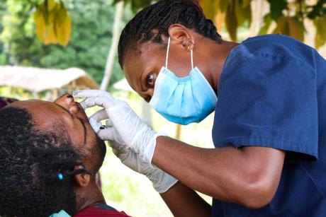 Kompiam volunteer dentist Philomina Baking attends to a patient at the Yambaitok community.