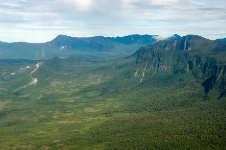 An aerial view of mountains and rugged forested terrain