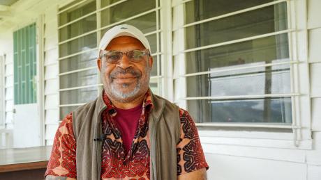 A man smiles at the camera