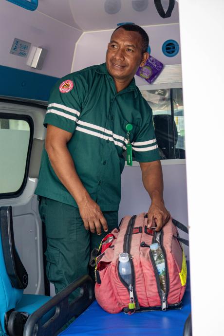 a medic prepares his medical bag in an ambulance