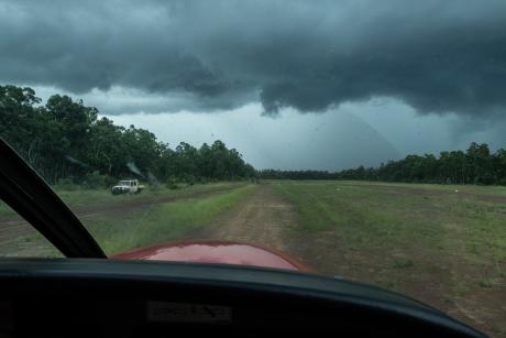 fourwheel drive vehicle and aircraft on red dirt airstrip