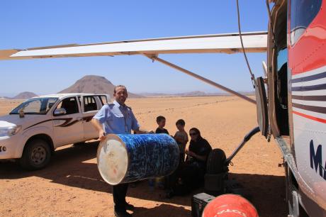 David placing a fuel drum into the plane