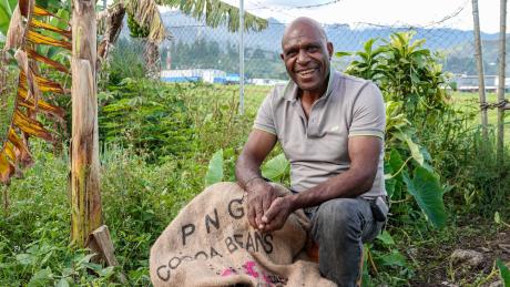 Tonny Yangu with bag of coffee beans
