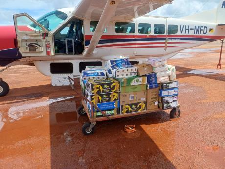 trolley of supplies on airport tarmac ready to be loaded inrto aircraft