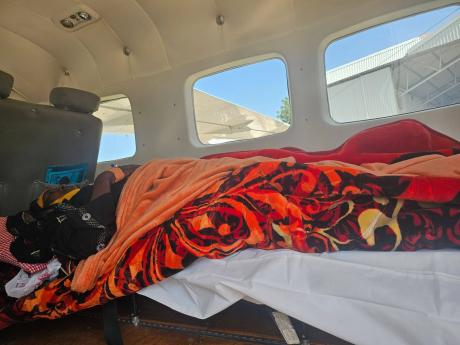 Aziza lying inside a MAF plane