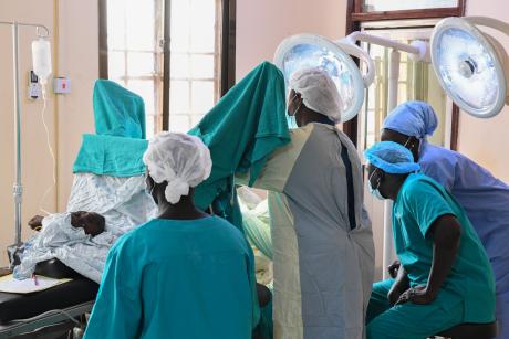 Dr. Achai and colleagues focus on a fistula patient on the surgical table 