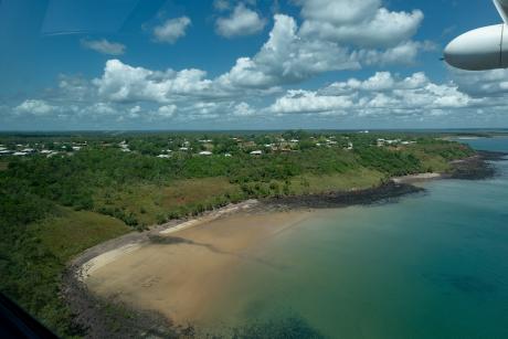 Aerial view on approach to small settlement by seaside