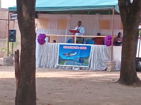 Banner bearing MAF plane hangs in front of the preacher