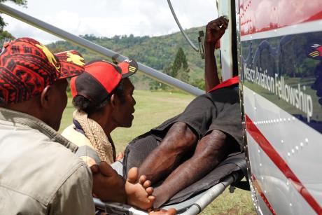 Patient being carried to a MAF plane.
