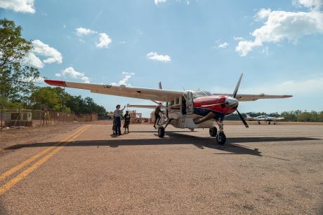 passengers boarding aircraft on concrete tarmac