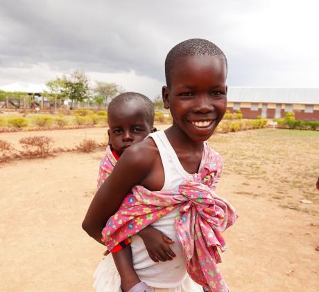 A child carrying a baby